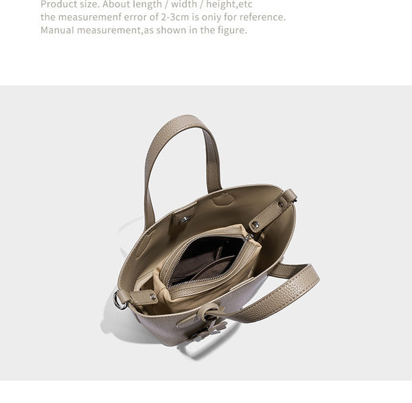 Compact pebbled bucket tote bag with elephant charm, twin top handles, and detachable crossbody strap, detail view 8