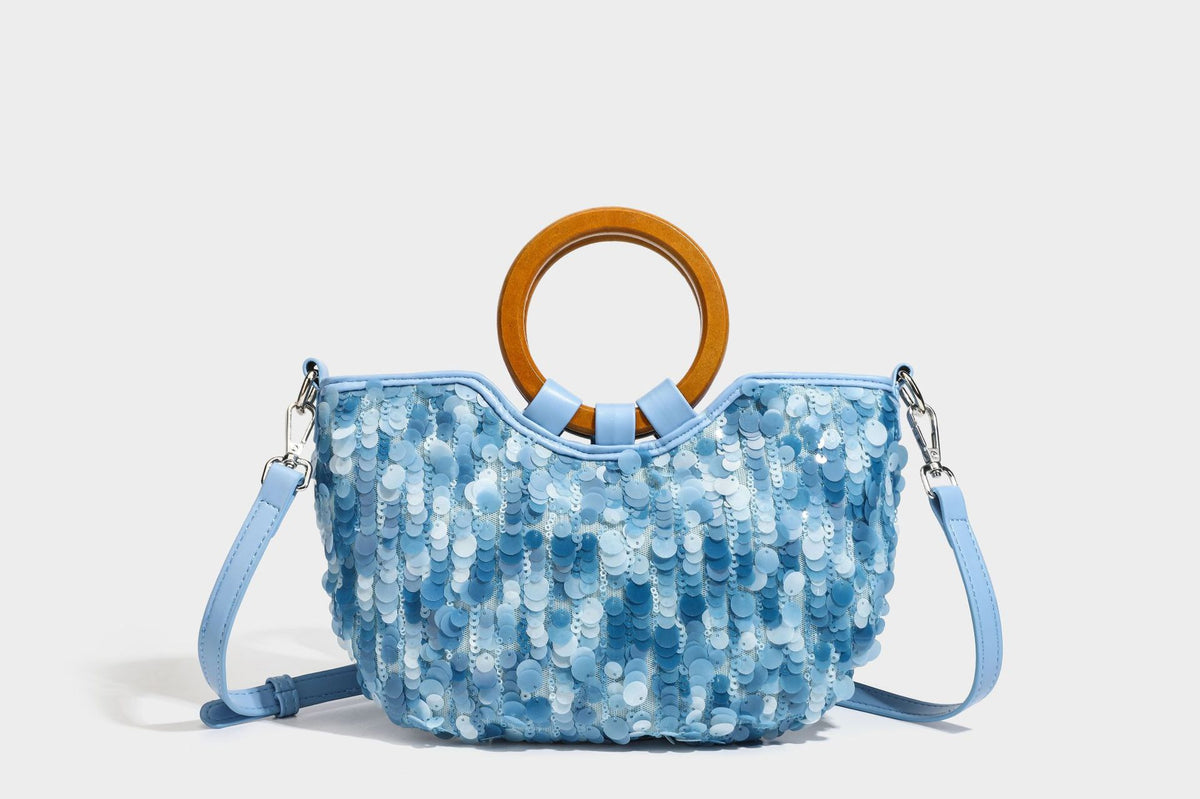 Small sequin half-moon handbag with circular wood-look ring handles and detachable leather-look shoulder strap, detail view