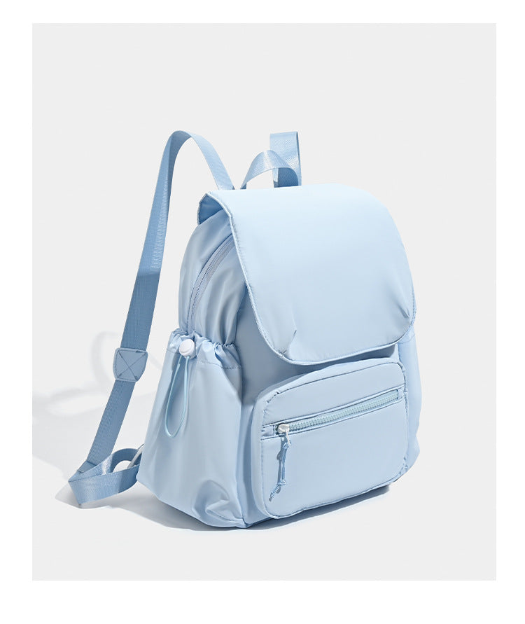Soft matte nylon flap backpack with front zip pocket and side drawcord pockets, detail view 16