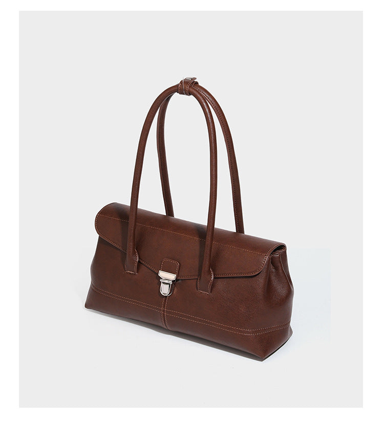 Structured rectangular satchel bag with dual rounded top handles and central metal turn-lock flap closure, detail view 8
