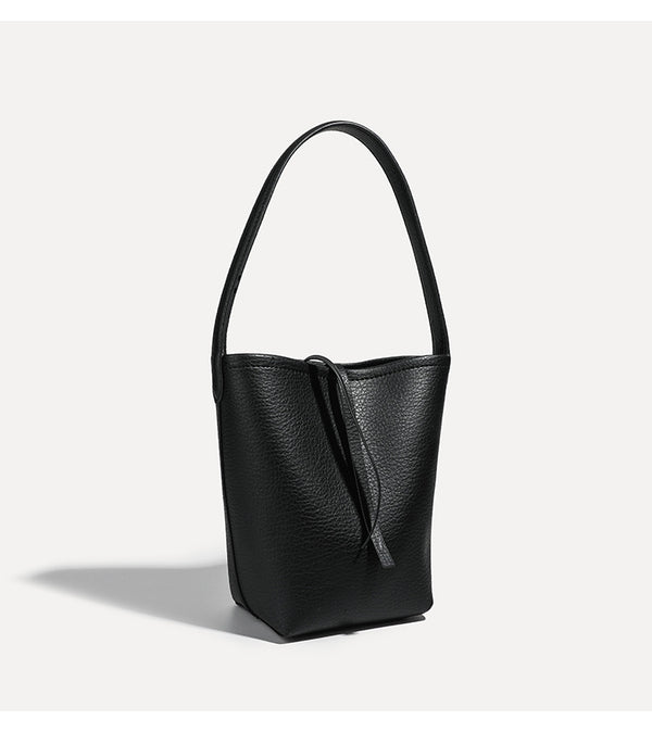 Mini tapered bucket bag in pebbled leather-look finish with front tie straps and single shoulder strap, detail view 17