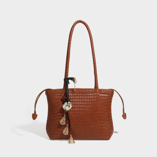 Structured woven leather-look tote bag in dark brown with long shoulder straps, side drawstring ties, and gold filigree