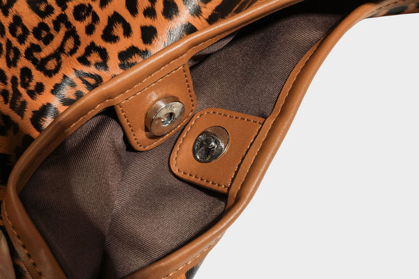 Glossy leopard-print slouchy shoulder bag with long strap and detachable tan zip pouch, detail view 32