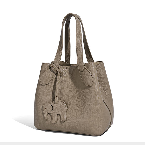 Compact pebbled bucket tote bag with elephant charm, twin top handles, and detachable crossbody strap, detail view 5