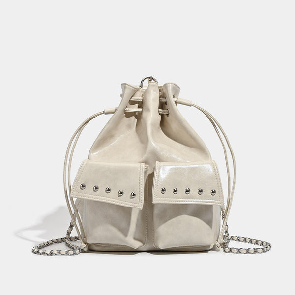 Glossy leather-look drawstring bucket bag with silver dome studs and chain shoulder strap, detail view 7