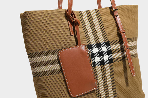 Large structured plaid check tote bag with smooth tan leather-look shoulder straps, attached front zip pouch, and gold-tone