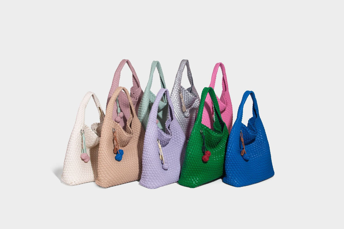 Soft hand-woven slouchy hobo tote bag with knotted tassel charm and single looped shoulder strap, detail view 23
