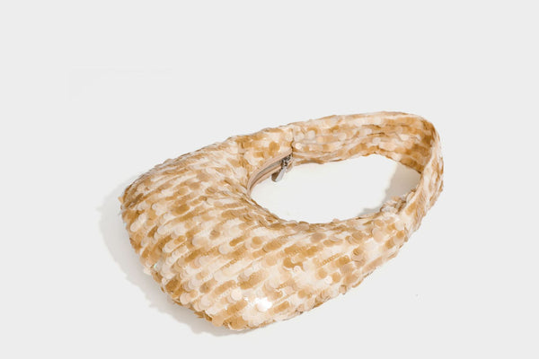 Slouchy crescent hobo shoulder bag covered in overlapping reflective sequin discs with a single integrated strap and top-zip
