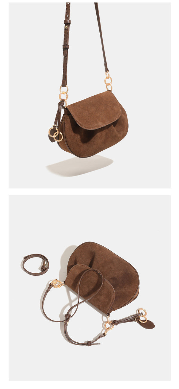 Small rounded flap crossbody saddle bag with gold-tone ring hardware and adjustable strap, detail view 12