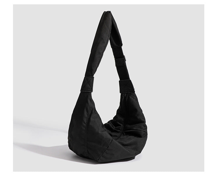 Large crescent sling shoulder bag in gathered fabric with zip closure and adjustable strap, detail view 13