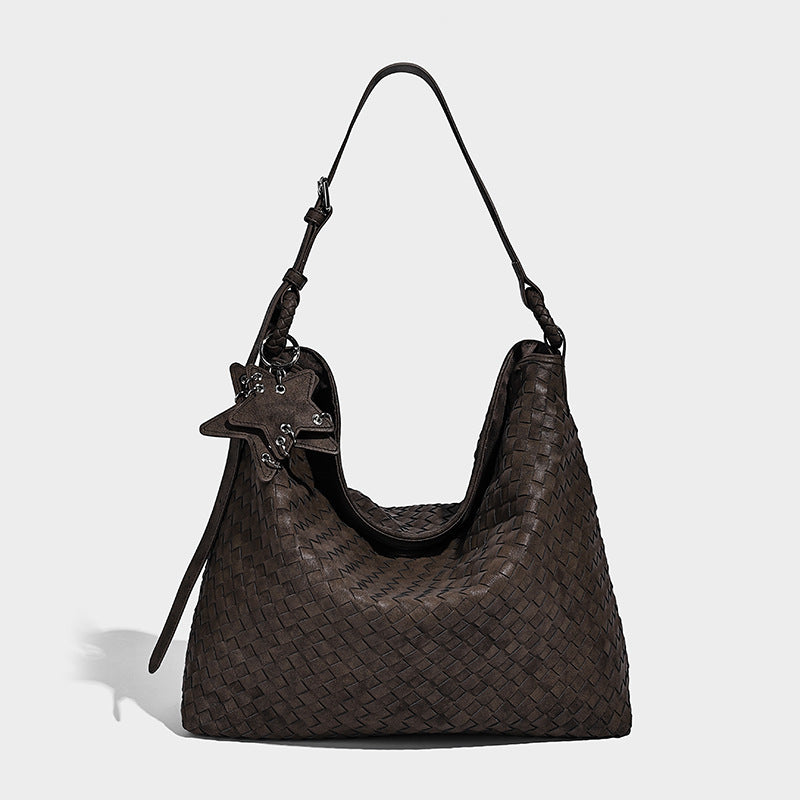 Large soft woven hobo shoulder bag with matte textured finish, adjustable strap, and star charm hardware, detail view 6