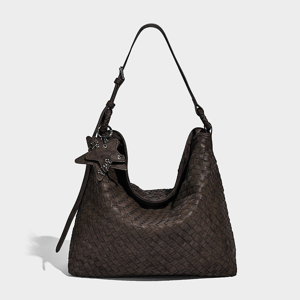 Large soft woven hobo shoulder bag with matte textured finish, adjustable strap, and star charm hardware, detail view 6