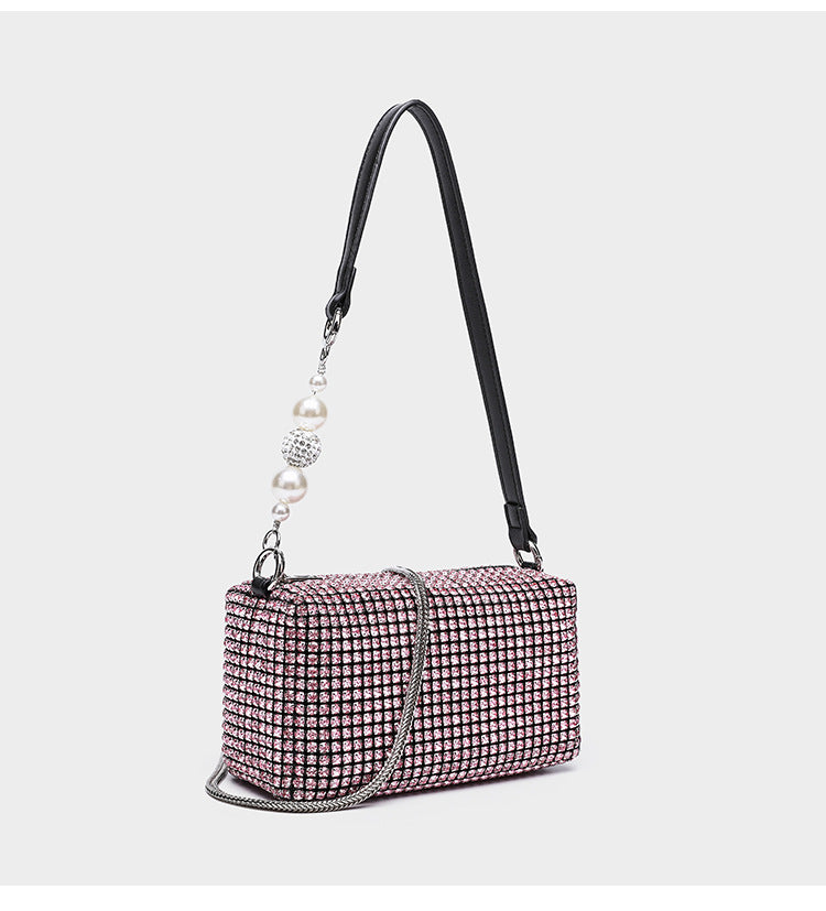 Small rectangular all-over rhinestone crossbody bag with pearl bead zipper pull and detachable silver chain strap, detail