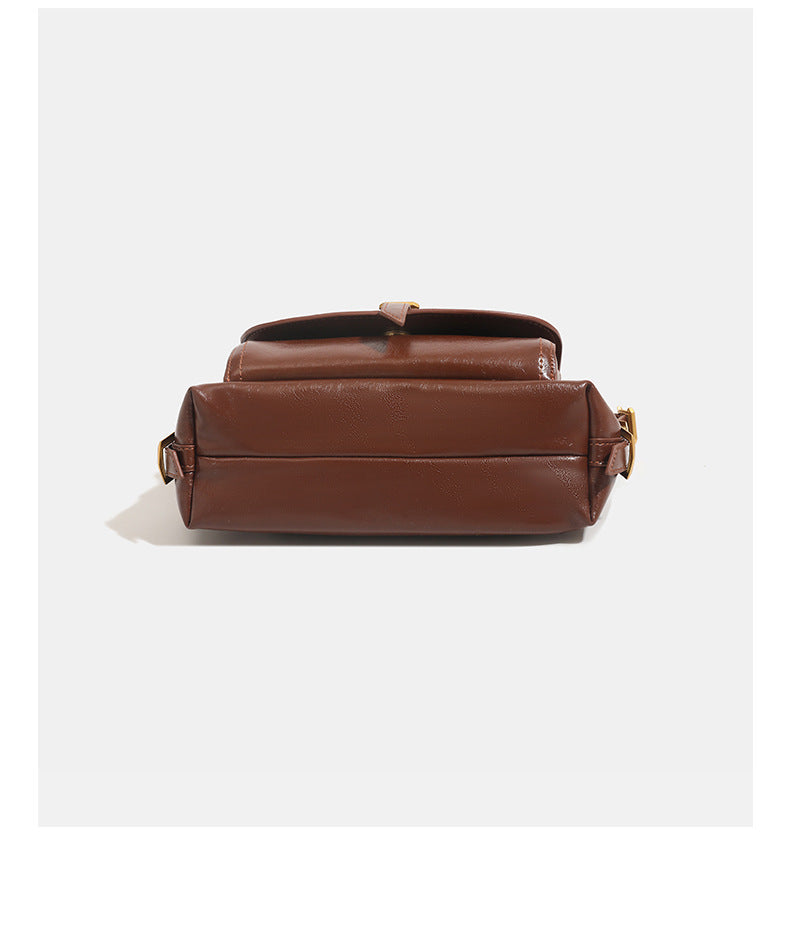 Compact glossy oil-wax leather-look shoulder bag with front buckle flap pocket and gold-tone hardware, detail view 14