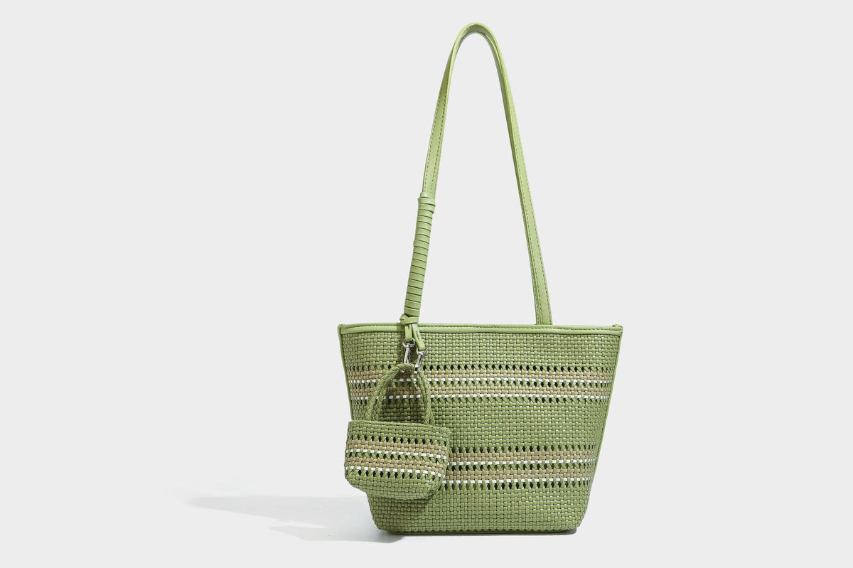 Large structured woven tote bag with striped basket-weave finish, long shoulder straps, and detachable mini pouch charm