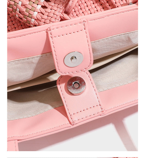 Large structured woven tote bag with striped basket-weave finish, long shoulder straps, and detachable mini pouch charm