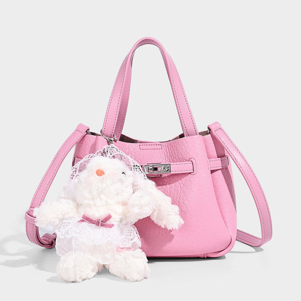 Small structured pebbled bucket tote with double top handles, silver turn-lock hardware, and detachable shoulder strap