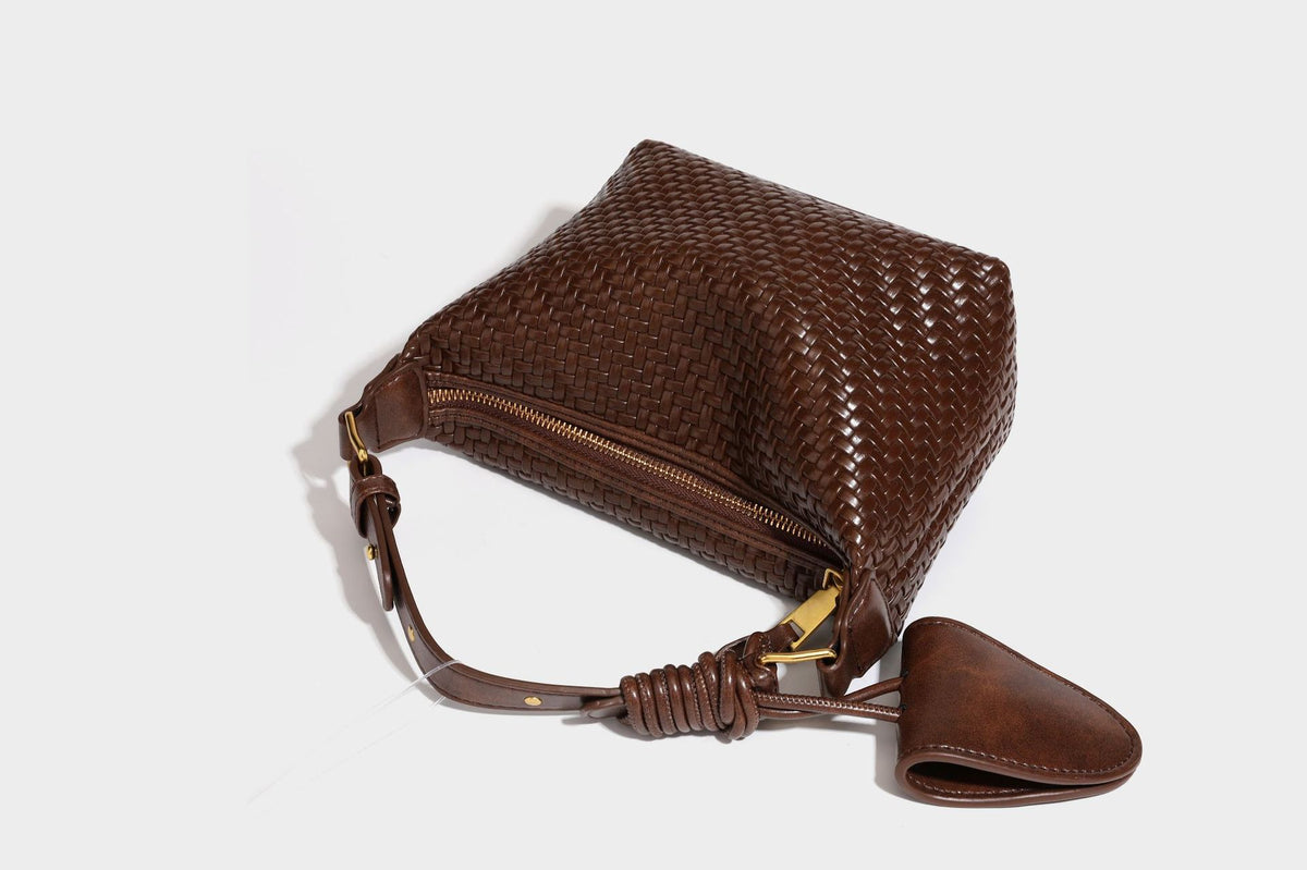 Small glossy basket-weave hobo shoulder bag in brown with knotted top handle, flap accent pocket, and gold-tone hardware
