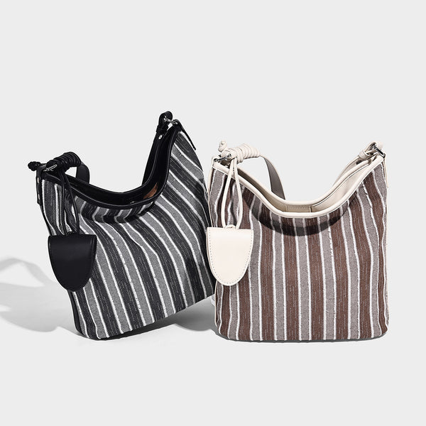 Large striped canvas hobo shoulder bag with cream trim and silver-tone hardware, detail view 2