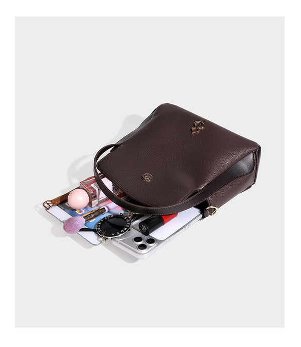 Structured pebbled leather-look shoulder bag with flap top, gold-tone emblem hardware, dual top handles, and detachable