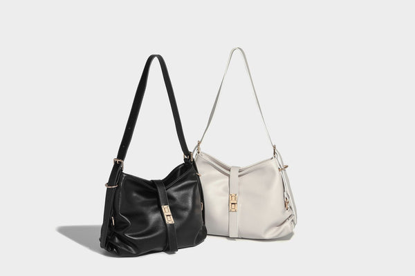 Soft slouchy hobo shoulder bag with smooth leather-look finish, gold-tone buckle and tab hardware, and long adjustable strap