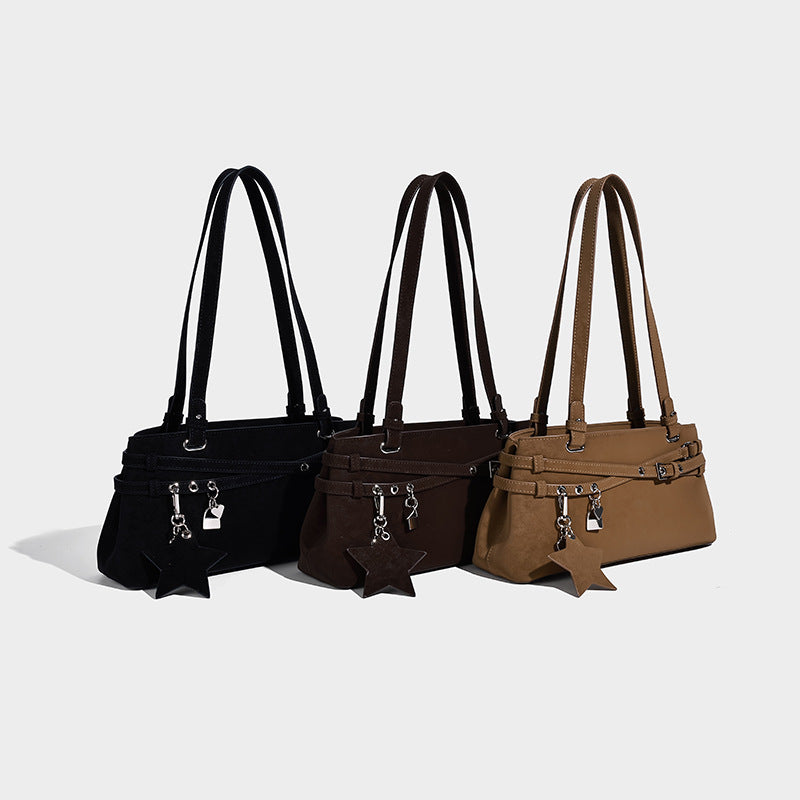 Structured trapezoid shoulder tote in dark brown matte suede-look finish with dual straps, wraparound belt bands