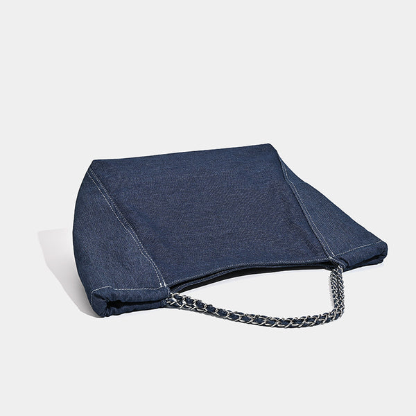 Large slouchy denim tote bag with silver-tone chain strap and contrast topstitching, detail view 4