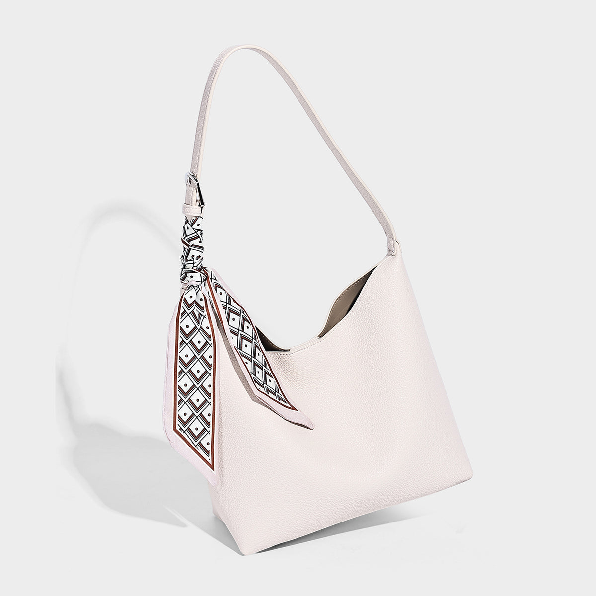 Soft slouchy hobo shoulder bag in pebbled matte finish with slim strap, silver-tone ring hardware, and knotted printed scarf