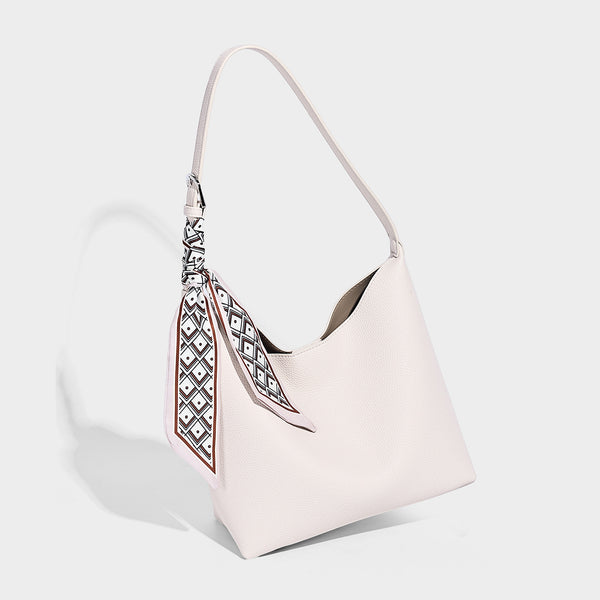 Soft slouchy hobo shoulder bag in pebbled matte finish with slim strap, silver-tone ring hardware, and knotted printed scarf