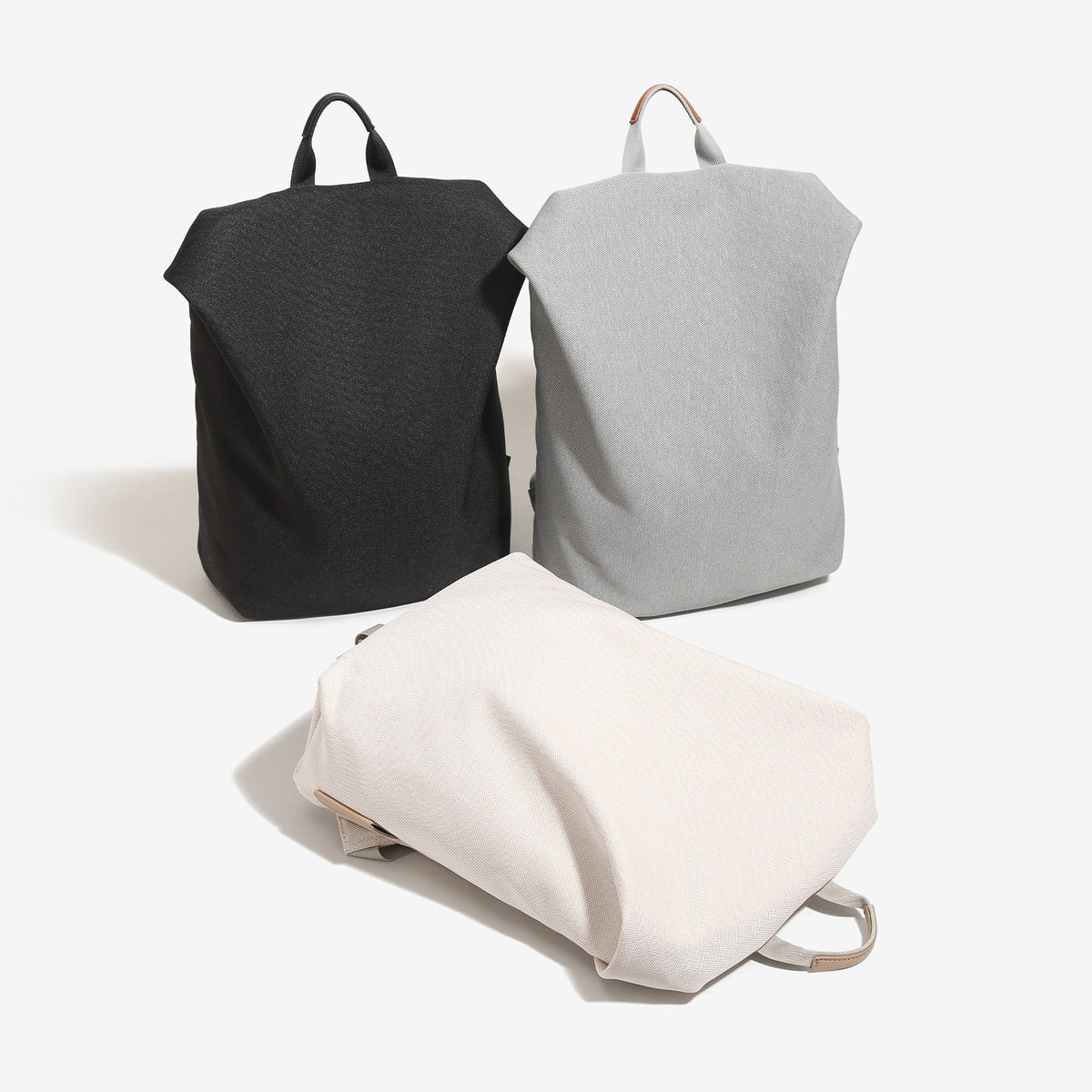 Minimalist matte woven backpack handbag with short top handle and adjustable shoulder straps, detail view 2