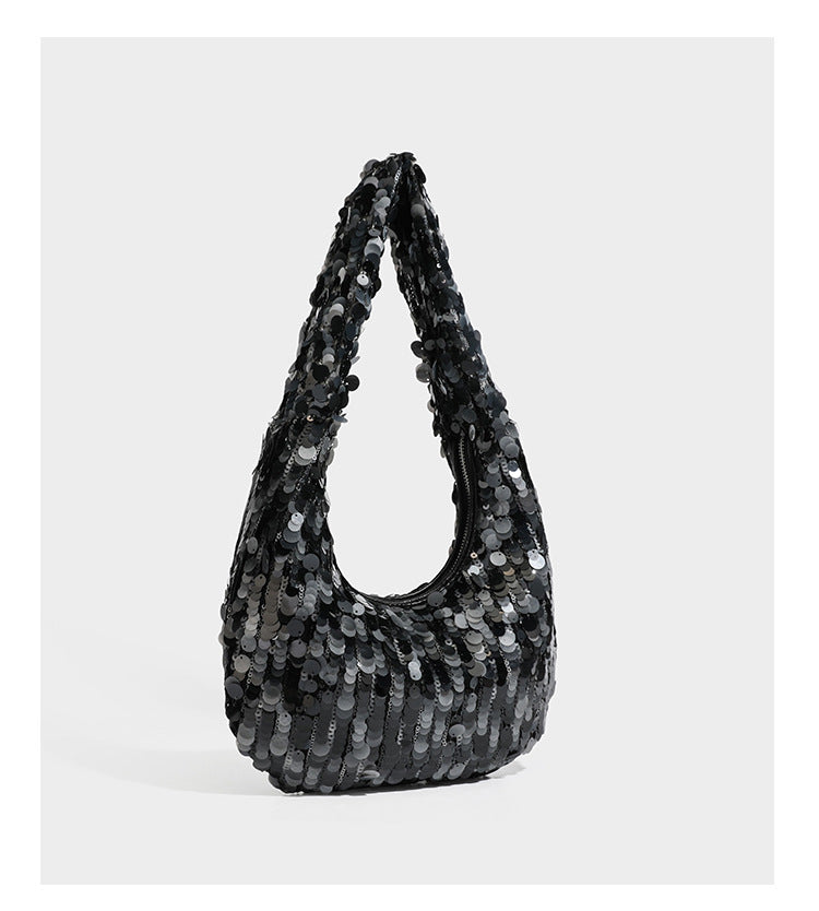 Slouchy crescent hobo shoulder bag covered in overlapping reflective sequin discs with a single integrated strap and top-zip