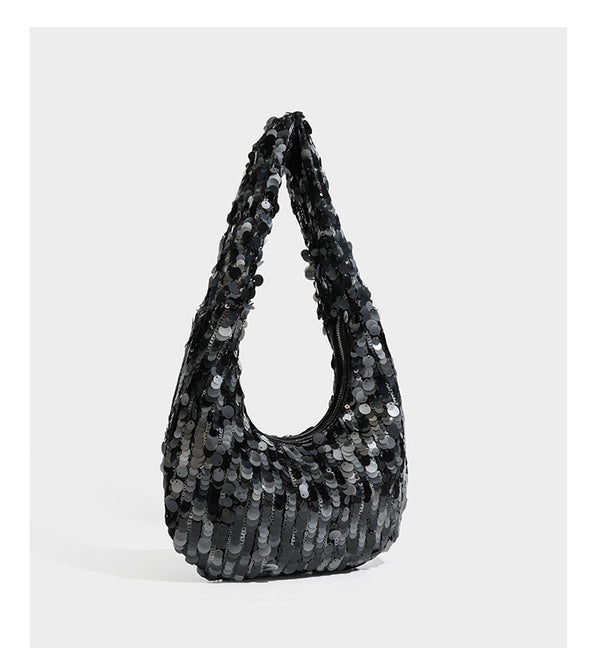 Slouchy crescent hobo shoulder bag covered in overlapping reflective sequin discs with a single integrated strap and top-zip