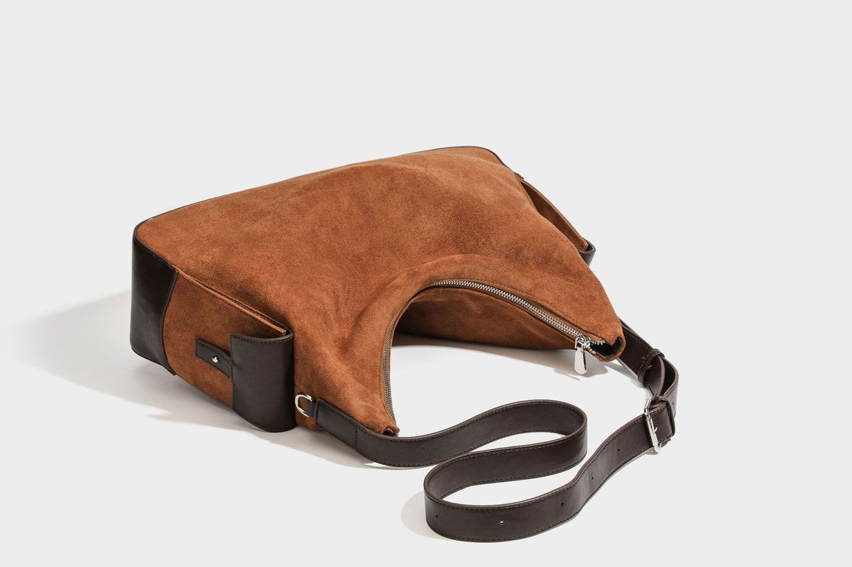 Slouchy cognac brown matte suede-look hobo shoulder bag with dark brown leather-look trim, top zip closure, front flap