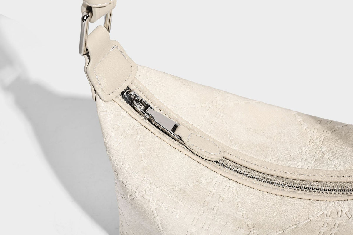Small embossed half-moon shoulder bag with top zipper, detachable front pouch, and adjustable slim strap, detail view 22
