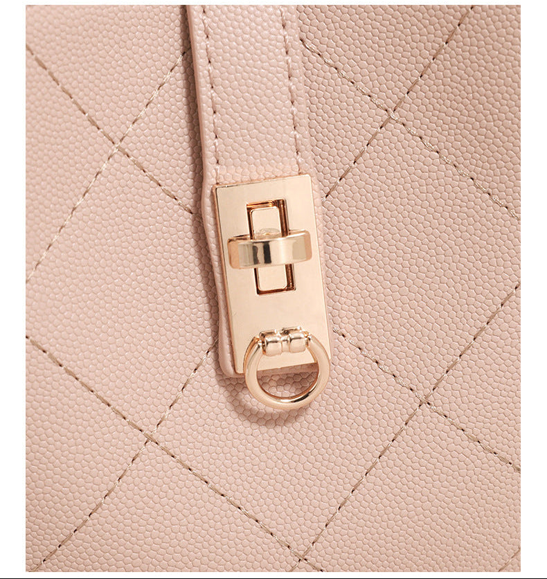 Mini diamond-quilted pebbled-finish bucket bag with gold-tone turn-lock closure and top handle, detail view 14