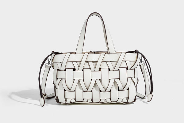 Structured woven basket tote handbag with contrasting dark trim, double top handles, detachable shoulder strap, and