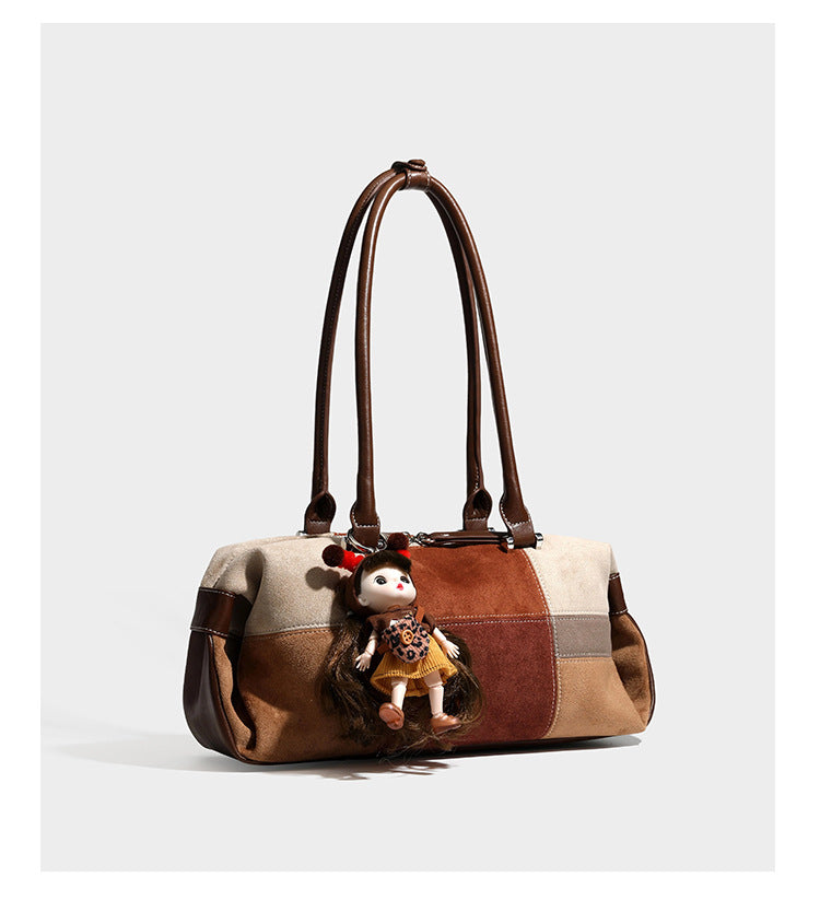 Patchwork suede-look barrel shoulder bag in brown, rust, tan, beige, and gray panels with double leather-look straps and