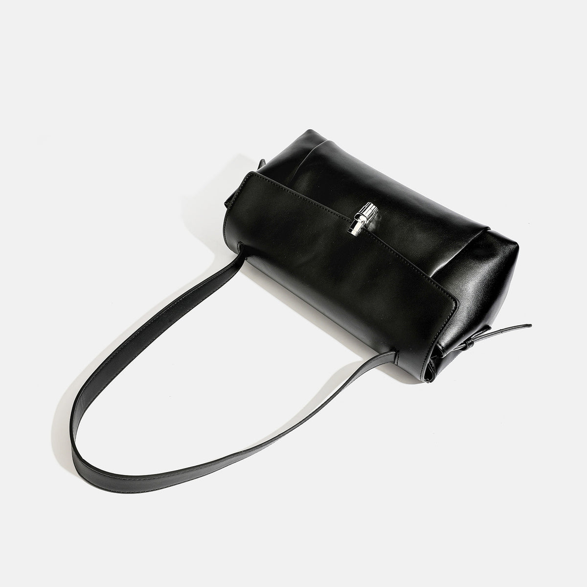 Structured rectangular flap shoulder bag with smooth leather-look finish, silver-tone turn-lock clasp, and long slim