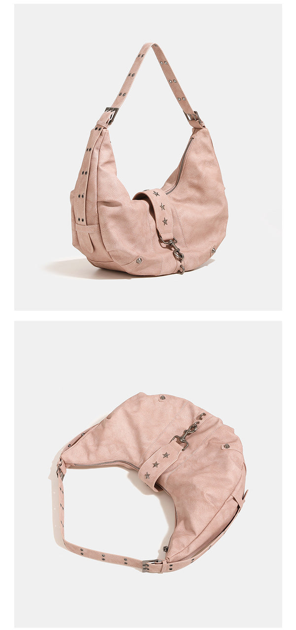 Crescent hobo shoulder bag in matte leather-look finish with star stud front panel, antique-silver hook hardware, and, detail