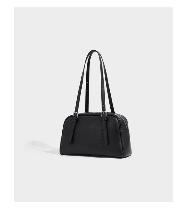 Structured dome-shaped shoulder bag with leather-look finish, top zipper closure, dual adjustable slim straps, and, detail