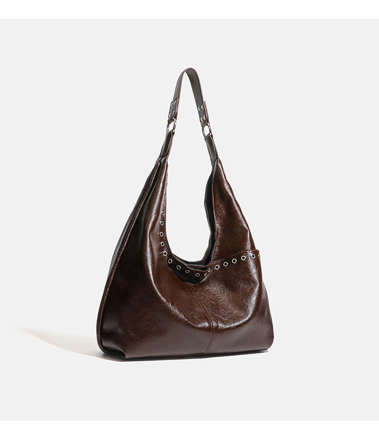 Large slouchy hobo shoulder bag with silver eyelet trim and glossy leather-look finish, detail view 12