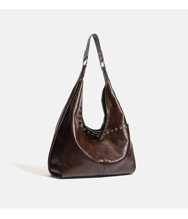 Large slouchy hobo shoulder bag with silver eyelet trim and glossy leather-look finish, detail view 12