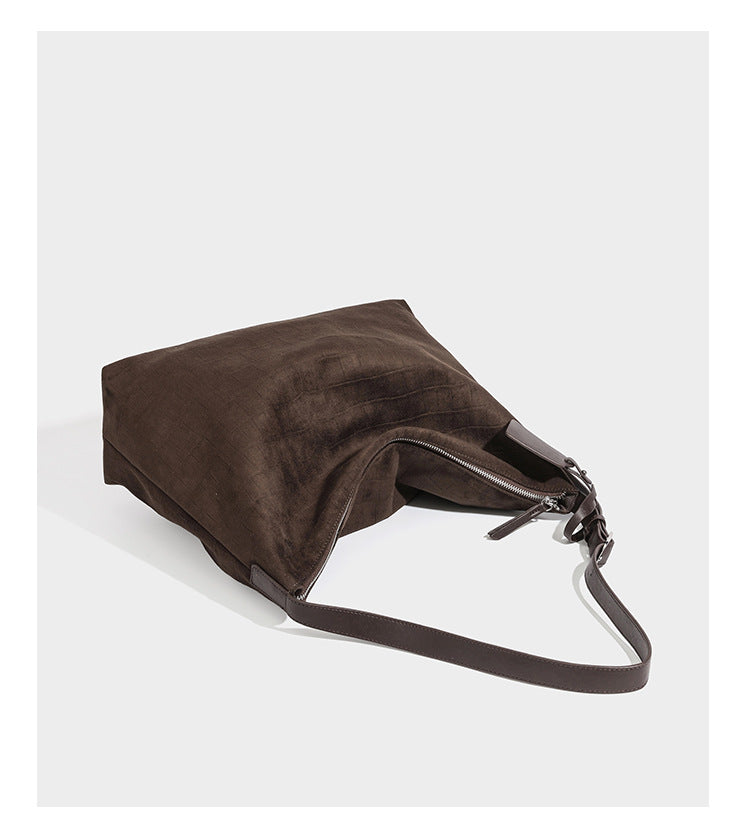 Slouchy hobo shoulder bag in matte croc-embossed leather-look finish with top zip closure and long adjustable strap, detail