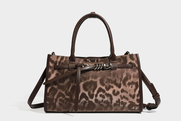 Structured leopard-print tote bag with glossy satin-like finish, dual rounded top handles, silver buckle-and-ring front