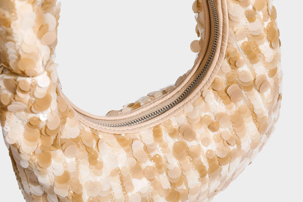 Slouchy crescent hobo shoulder bag covered in overlapping reflective sequin discs with a single integrated strap and top-zip