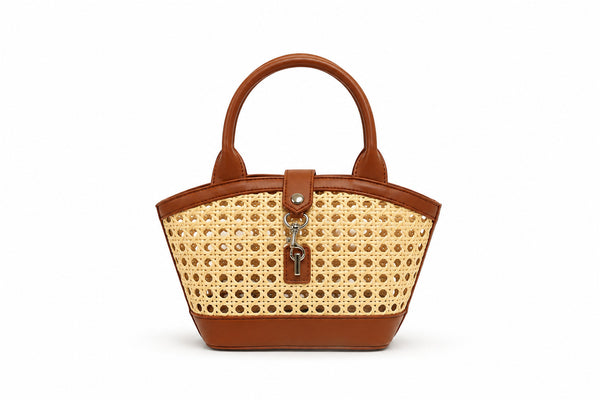 Structured mini tote bag with open-weave rattan body, leather-look arched handles and trim, front tab turn-lock closure, and