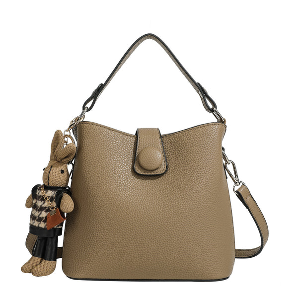 Structured taupe pebbled-texture bucket bag with top handle, silver ring hardware, tab-and-button closure, and knit bunny