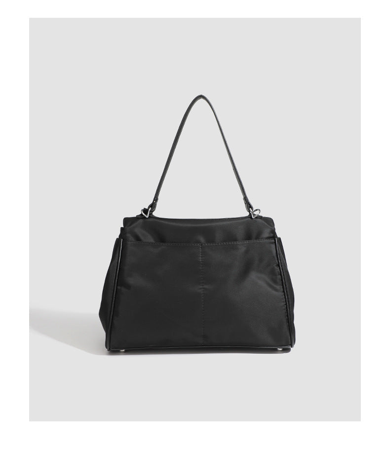 Structured black leather-look flap satchel bag with silver turn-lock hardware and top handle, detail view 29