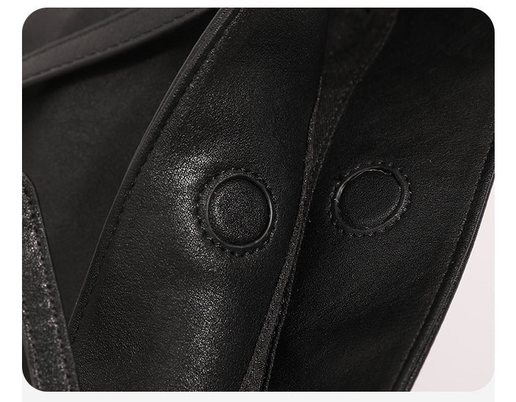 Structured black leather-look bucket tote bag with slim shoulder straps, silver-tone stud hardware, and tapered body, detail