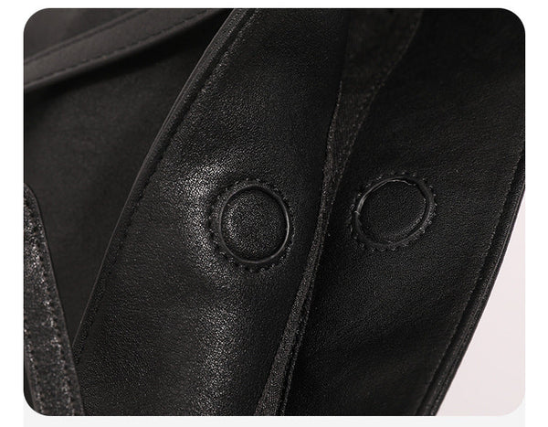 Structured black leather-look bucket tote bag with slim shoulder straps, silver-tone stud hardware, and tapered body, detail